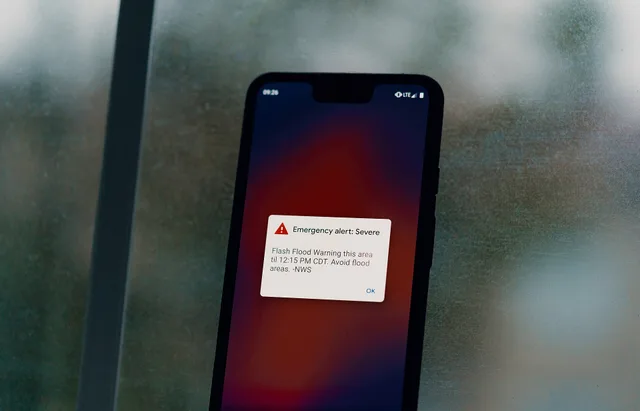 An emergency weather alert from the National Weather Service warns of a flash flood warning on an Android Pixel 3 XL smartphone, during a thunderstorm in Austin, Texas: "Emergency alert: Severe - Flash Flood Warning this area til 12:15 PM CDT. Avoid flood areas. -NWS". Crisis communications case studies: the Hawaii alert and one airline's recovery