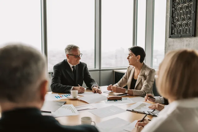 Business professionals engaged in a strategic meeting in a modern office setting with natural light. A field guide to marketing communications strategy signals worth tracking