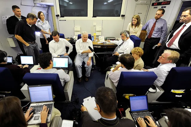 Defense Secretary Robert M. Gates speaks to the press aboard his aircraft, a U.S. Air Force E-4B National Airborne Operations Center, over the Pacific after attending the U.S. Pacific Command change-of-command ceremony on Camp Smith, Hawaii, Oct. 19, 2009. Gates is headed to Japan for defense talks. Quiet budget leaks hidden inside media relations mistakes