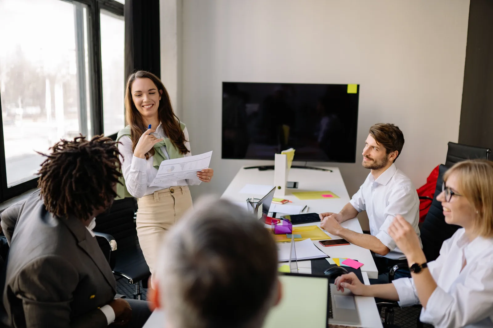 Team engaged in a collaborative office meeting, discussing ideas and planning strategies. Public relations strategy: the choices that shape everything else, 2027 edition